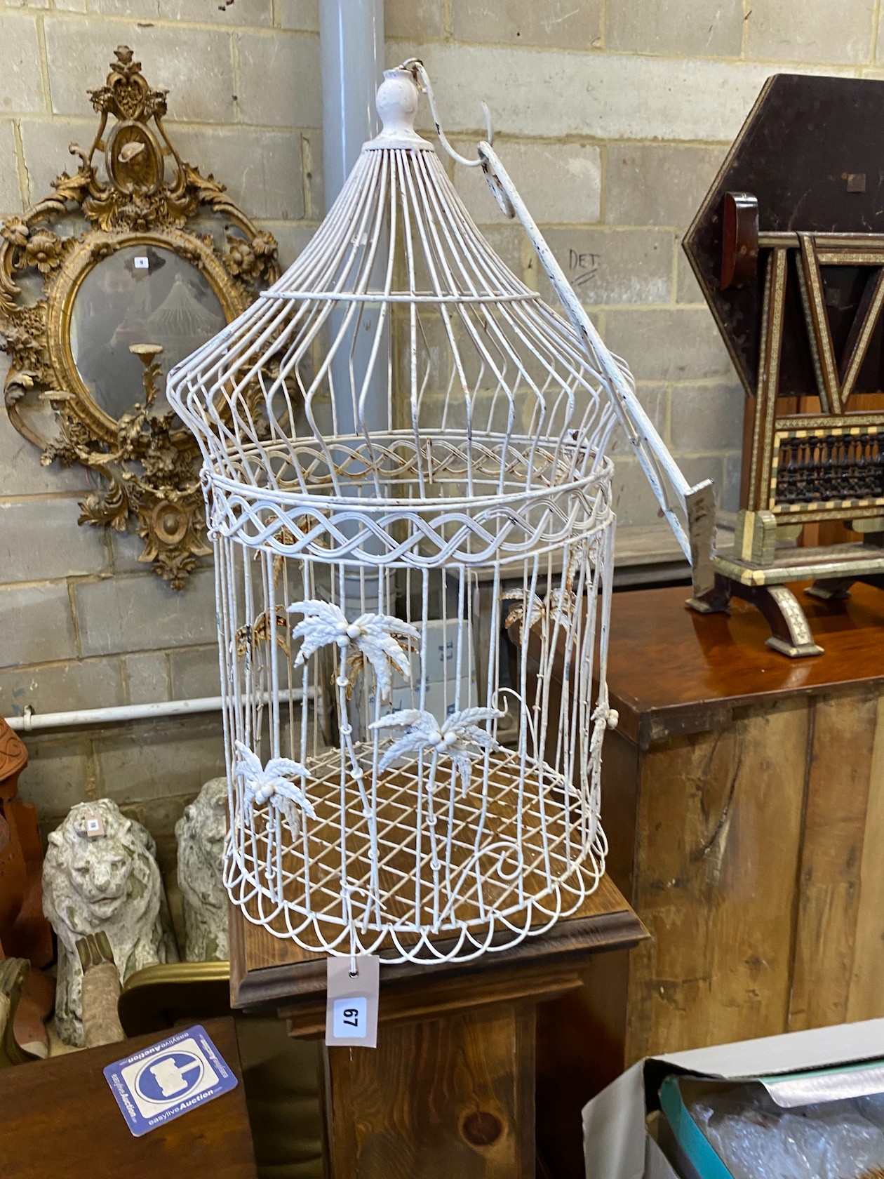 A stained pine pedestal with wirework bird cage, total height 174cm